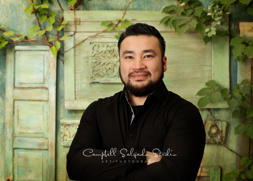 Commercial portrait of man on vintage green doors background by commercial photographers at Campbell Salgado Studio in Portland, Oregon. 