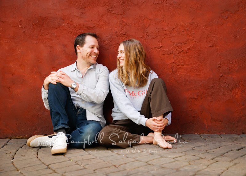  Portrait of father/daughter on red stucco background by family photographers at Campbell Salgado Studio in Portland, Oregon. 