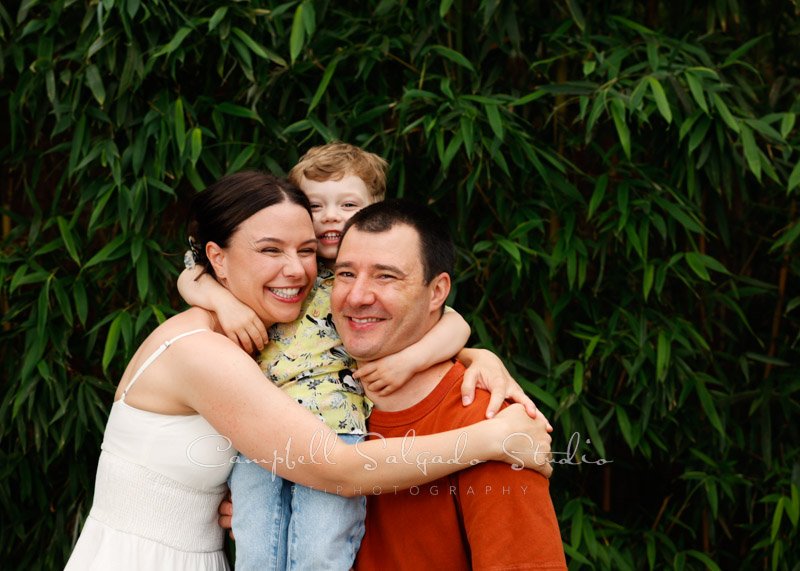  Portrait of family on bamboo background by family photographers at Campbell Salgado Studio in Portland, Oregon. 