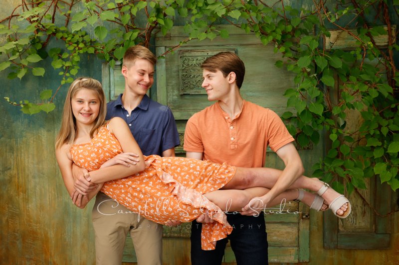  Portrait of family on vintage green doors background by family photographers at Campbell Salgado Studio in Portland, Oregon. 