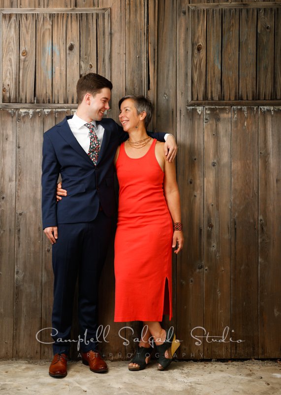  Portrait of couple on barn doors background by couple’s photographers at Campbell Salgado Studio in Portland, Oregon. 