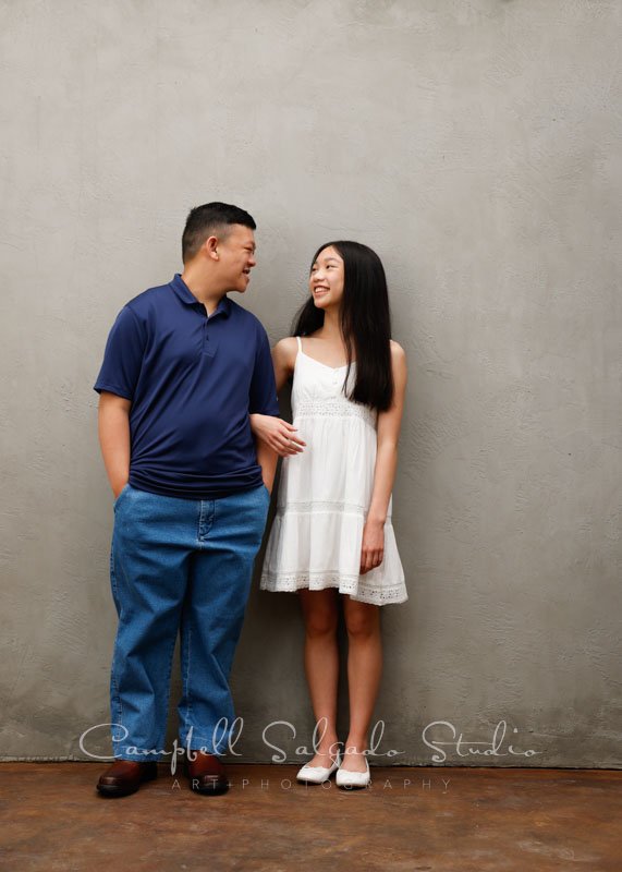  Portrait of siblings on modern gray background by family photographers at Campbell Salgado Studio in Portland, Oregon. 