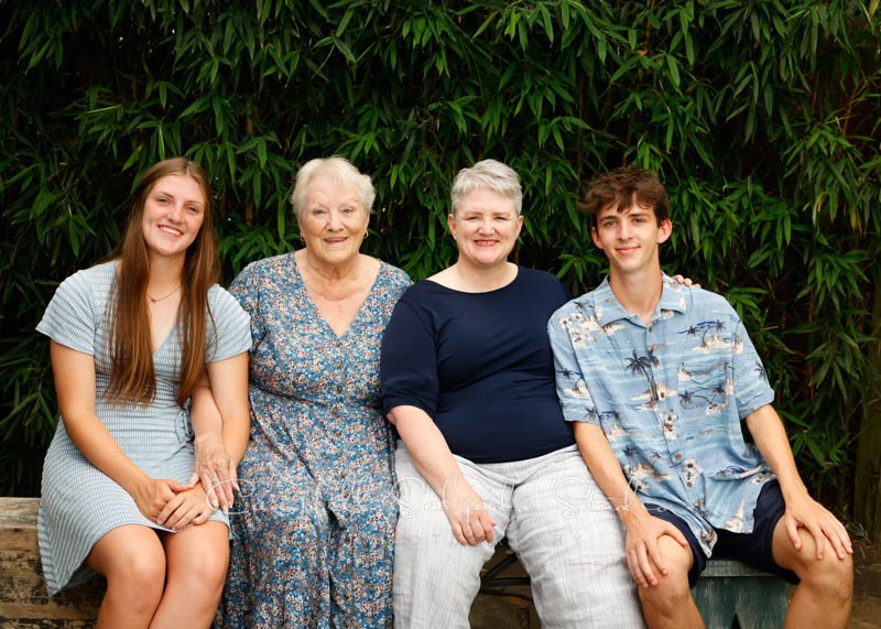  Portrait of family on bamboo background by family photographers at Campbell Salgado Studios in Portland, Oregon. 