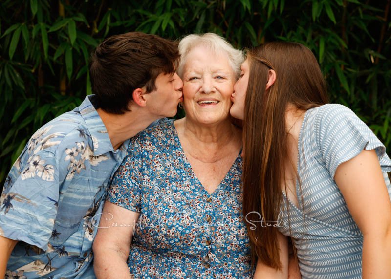  Portrait of family on bamboo background by family photographers at Campbell Salgado Studios in Portland, Oregon. 