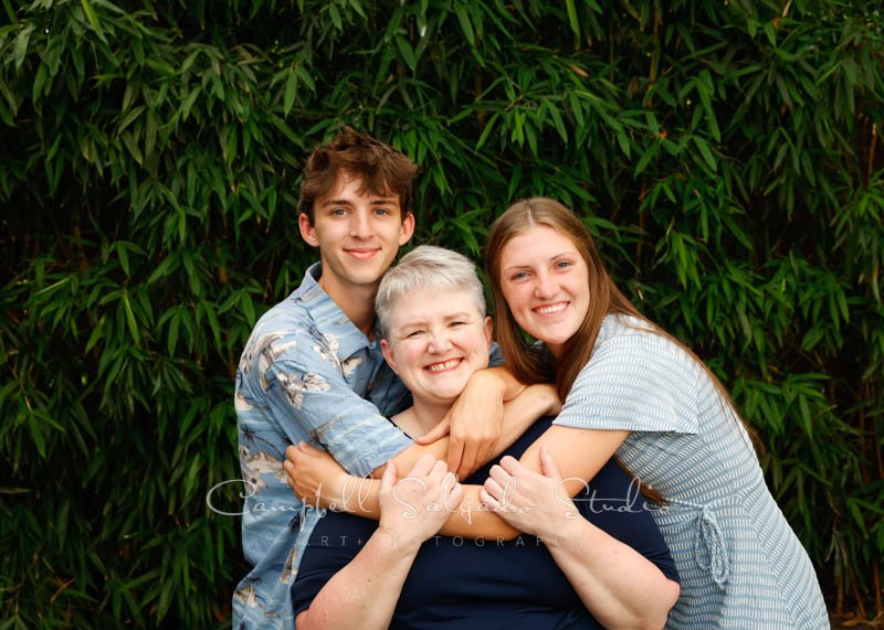  Portrait of family on bamboo background by family photographers at Campbell Salgado Studios in Portland, Oregon. 