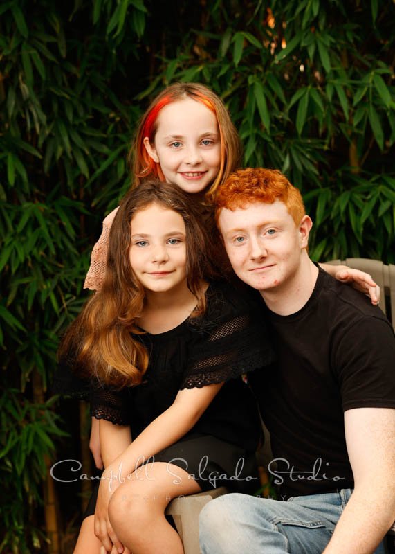  Portrait of family on bamboo background by family photographers at Campbell Salgado Studio in Portland, Oregon. 