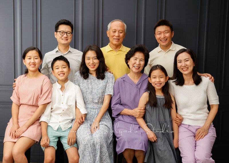  Portrait of multi-generational family on Portland Parlour background by family photographers at Campbell Salgado Studio in Portland, Oregon. 