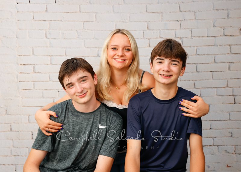  Portrait of siblings on ivory brick background by family photographers at Campbell Salgado Studio in Portland, Oregon. 