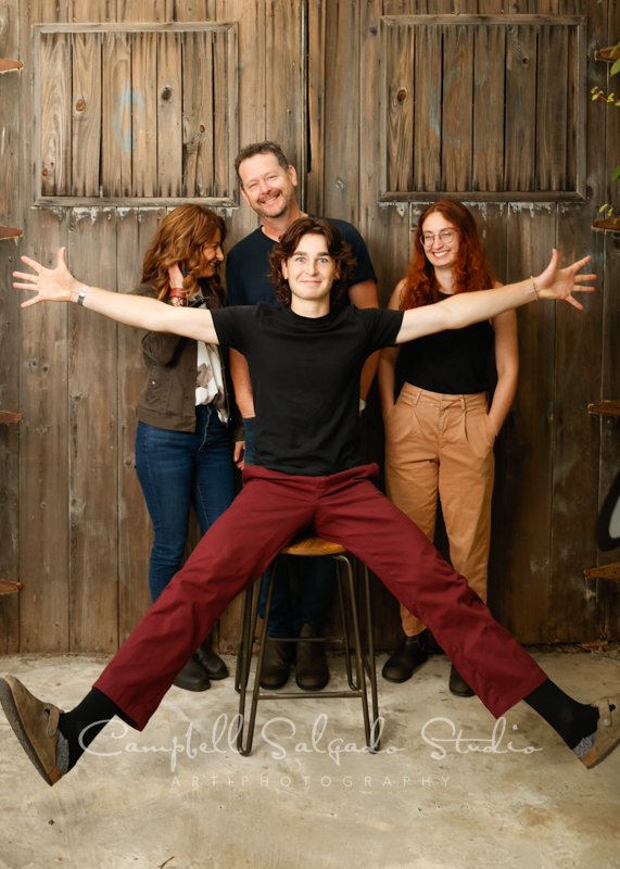  Portrait of family on barn doors background by family photographers at Campbell Salgado Studio in Portland, Oregon. 