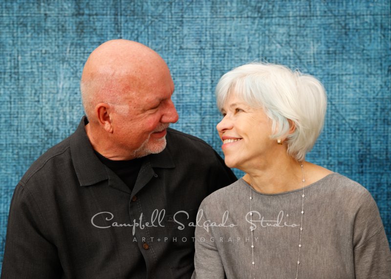  Portrait of couple and dog on denim background by couples’ photographers at Campbell Salgado Studio in Portland, Oregon. 