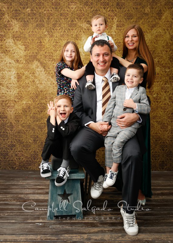  Portrait of family on amber light background by family photographers at Campbell Salgado Studio in Portland, Oregon. 