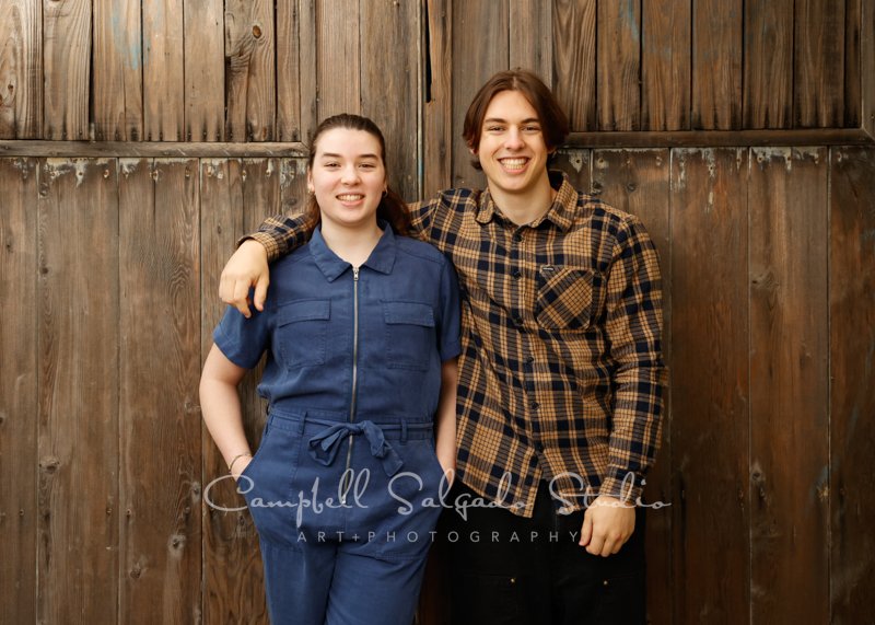  Portrait of family on barn doors background by family photographers at Campbell Salgado Studio in Portland, Oregon. 