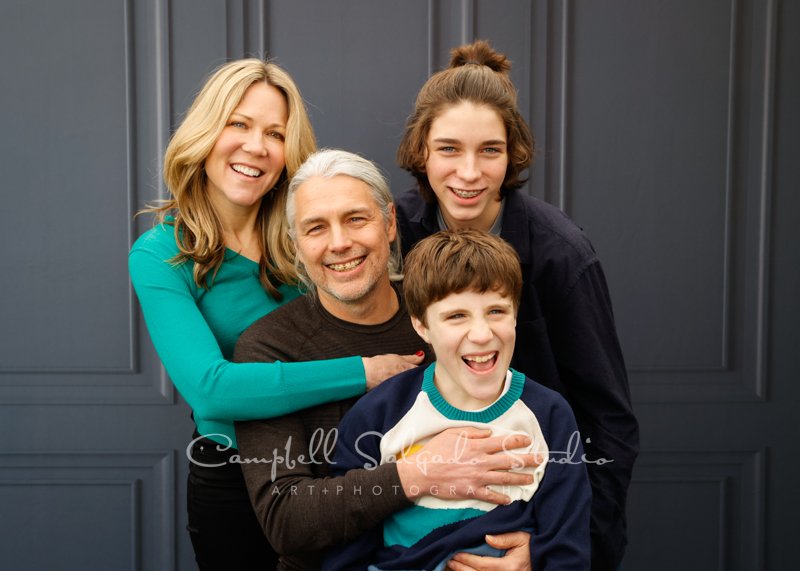  Portrait of family on the Portland Parlour background by family photographers at Campbell Salgado Studio in Portland, Oregon. 