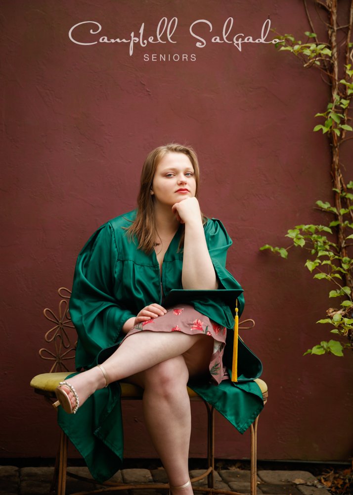  Portrait of college senior on plum stucco background by individual photographers at Campbell Salgado Studio in Portland, Oregon. 