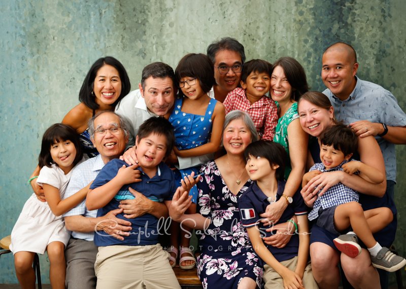  Portrait of multi-generational family on rain dance background by family photographers at Campbell Salgado Studio in Portland, Oregon. 