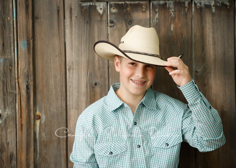  Portrait of teen on barn doors background by family photographers at Campbell Salgado Studio in Portland, Oregon. 