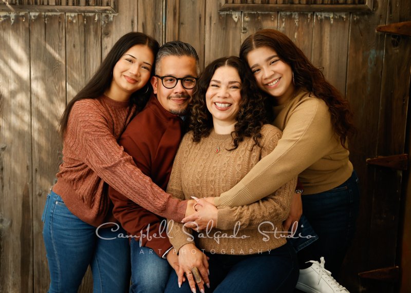  Portrait of family on barn doors background by family photographers at Campbell Salgado Studio in Portland, Oregon. 