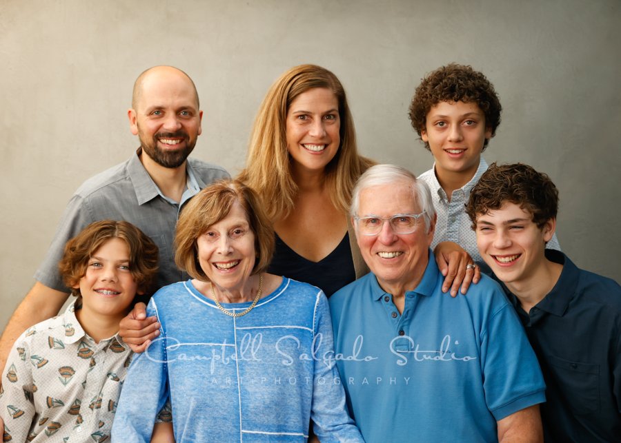  Portrait of multi-generational family on modern grey background by family photographers at Campbell Salgado Studio. 