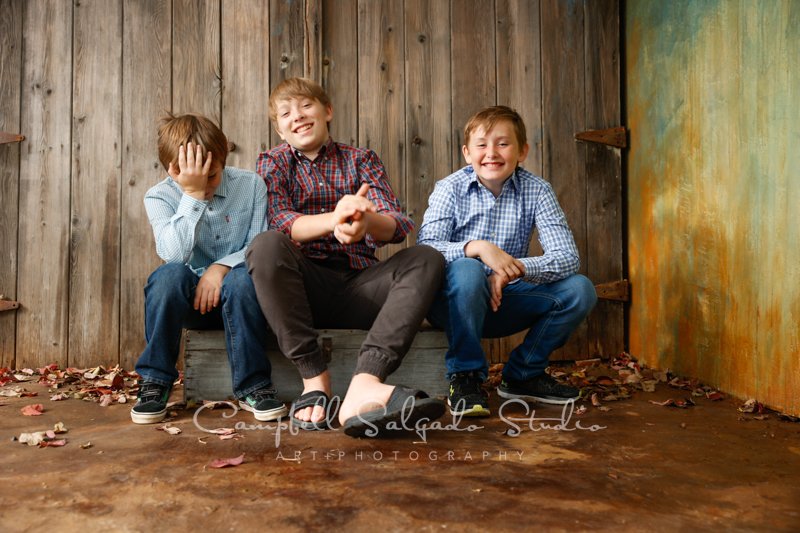  Portrait of boys on barn doors background by children’s photographers at Campbell Salgado Studio in Portland, Oregon. 