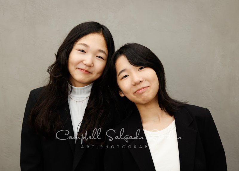  Portrait of sisters on modern grey background by family photographers at Campbell Salgado Studio in Portland, Oregon. 