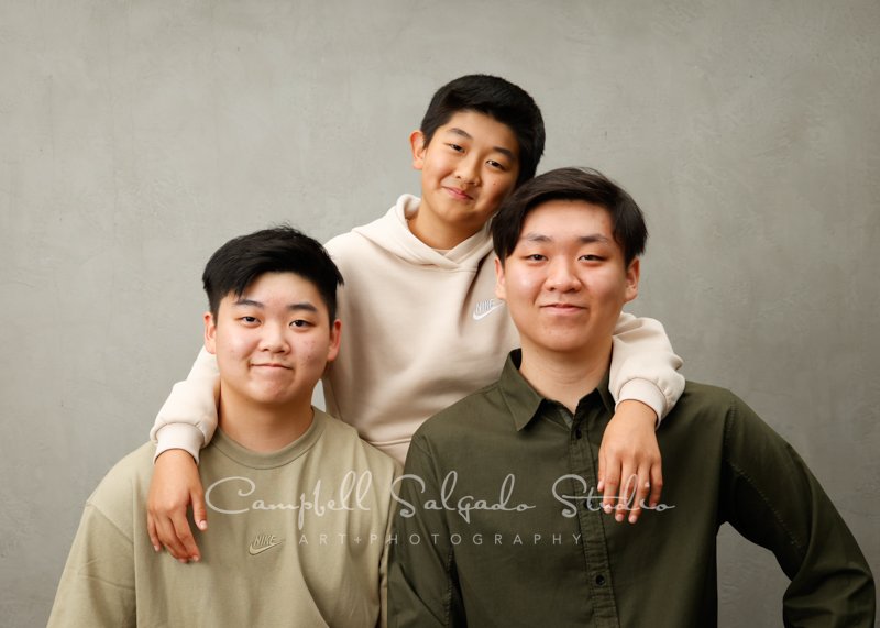  Portrait of family on modern grey background by family photographers at Campbell Salgado Studio in Portland, Oregon. 