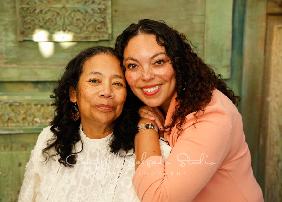  Portrait of mother and daughter on vintage green doors background by family photographers at Campbell Salgado Studio in Portland, Oregon. 