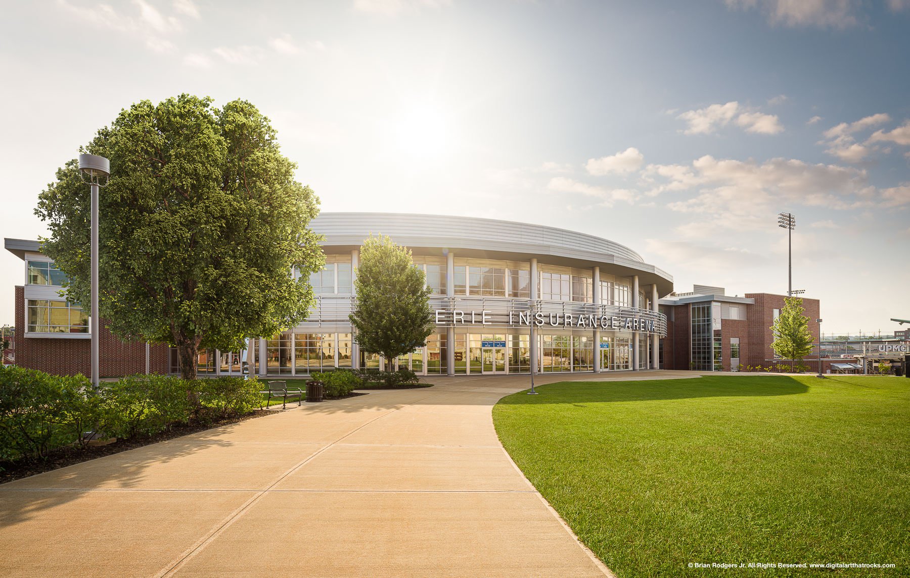 Exterior architectural photography of the Erie Insurance Arena in Erie, Pennsylvania, showing the curved glass facade and modern stadium design for architectural firms and construction companies.