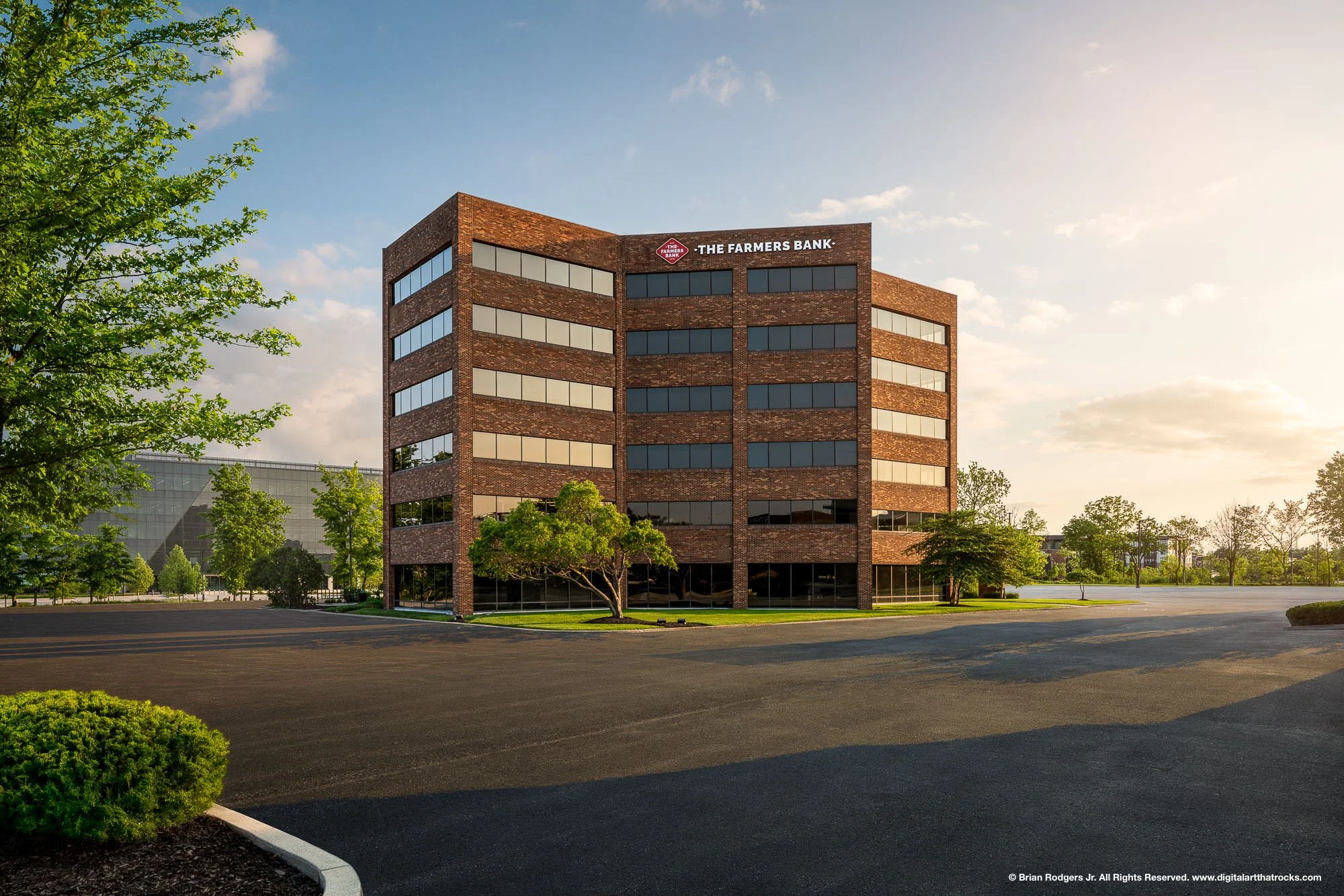 Golden hour exterior architectural photography of a multi-story brick commercial office building for The Farmers Bank in Carmel, Indiana, showcasing masonry and commercial construction quality.