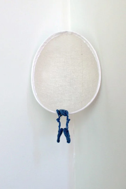 Lara Saget, Cradler, 2013; Hat, baby shoes, fishing wire; 6 x 8 x 3 inches