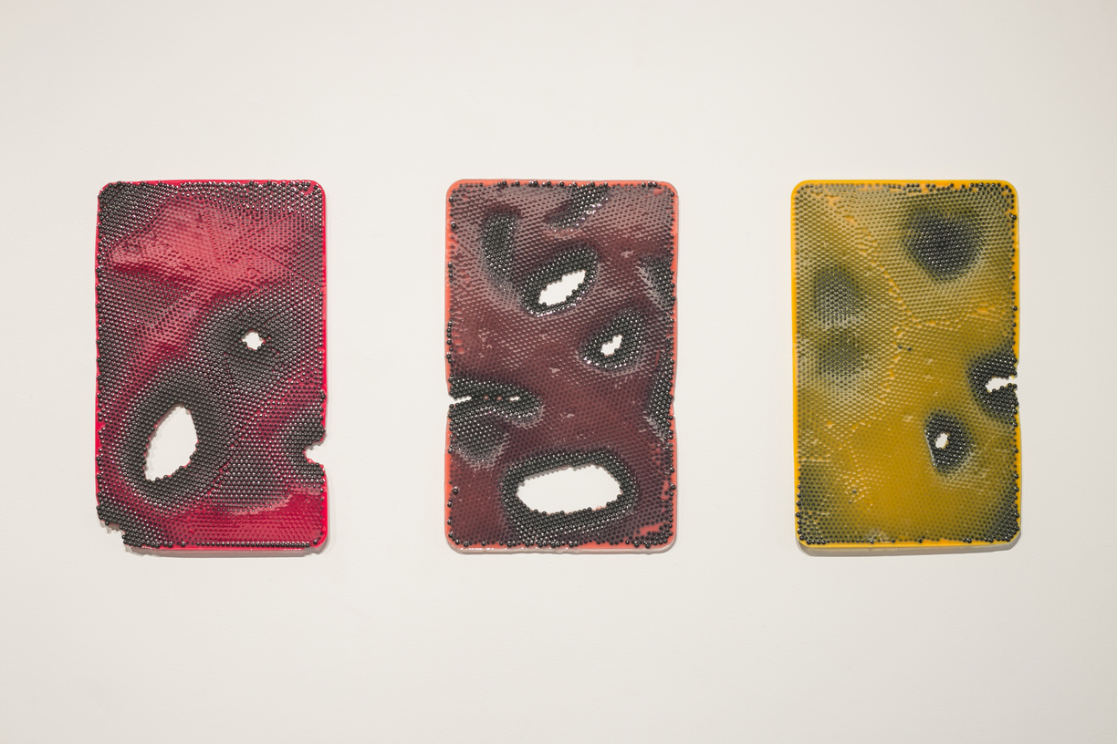  Jesse Greenberg From left to right:  Plate Set, Red Pox; Plate Set, Rose Pox; Plate Set, Yellow Pox  2014 Urethane plastic, pigment, ABS plastic 17 x 11 inches each 