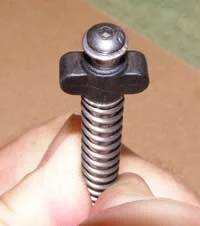 While the spring is held compressed fit the supplied washer and screw as shown above. Apply a small amount of Loctite to the screw threads before assembly and tighten the screw with the supplied wrench.