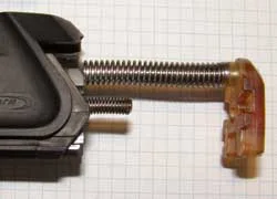 The supplied buffer is a tight push fit onto the guide rod. Position it as shown.