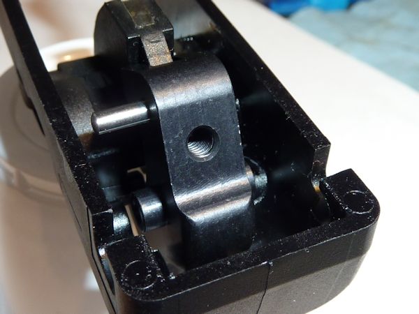Using the small Allen wrench supplied with the parts kit screw the trigger adjustment screw into position so that the tip of the screw is flush with the rear face of the trigger (in the cavity at the rear of the trigger). Assemble the trigger/trigger spring/hammer linkage/trigger pivot pin group into the trigger housing. Hammer Parts Replacing the hammer parts should be fairly straight forward. Initial Adjustments. Now the job gets a little more tricky. We need to make initial adjustments to the trigger adjustment screw before we continue. This is a critical adjustment. This is probably how the catch at the rear of the trigger housing will look at this point.