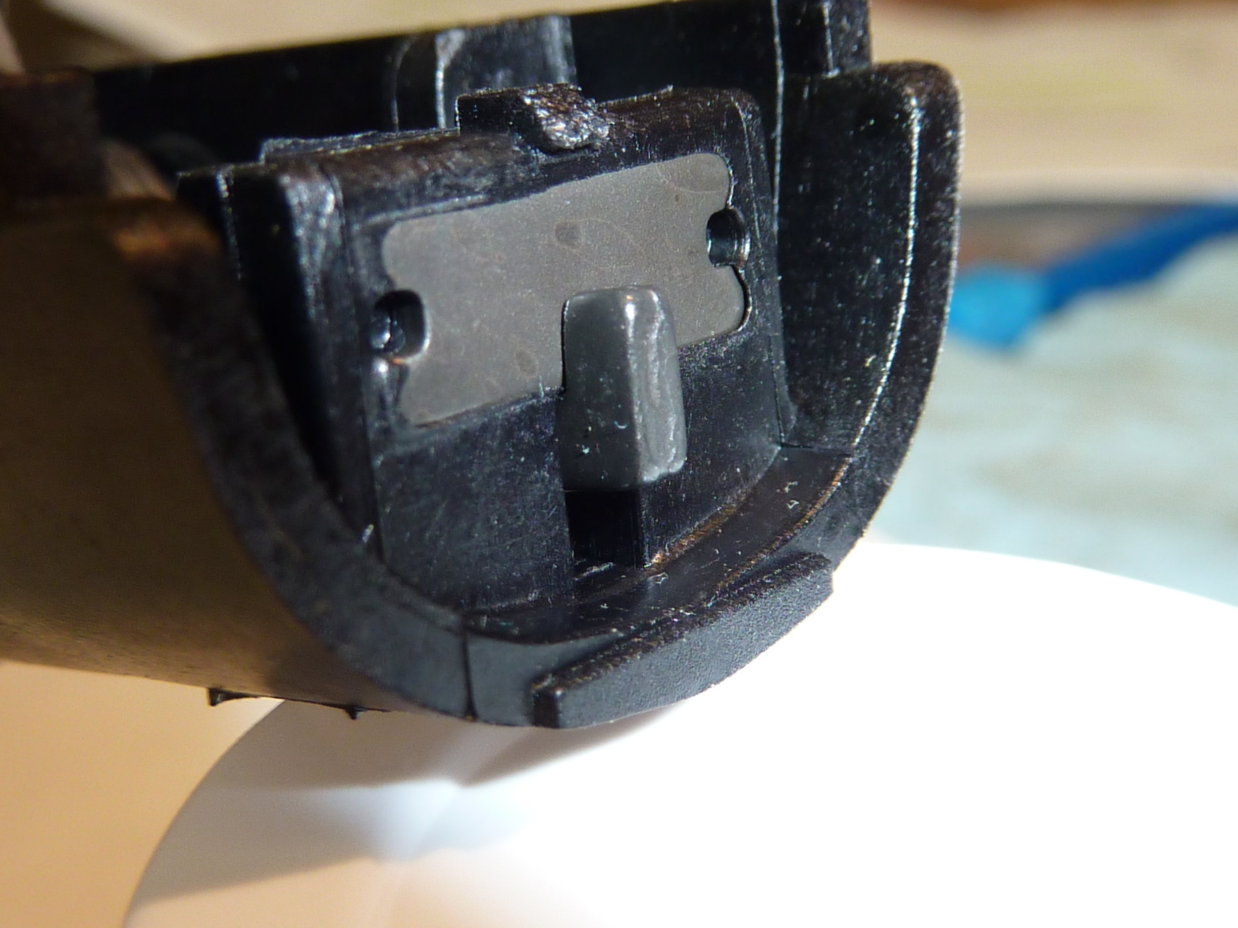 Note that the little hook is in the fully engaged position. Now, screw in the trigger adjustment screw until it starts to contact the trigger housing body. This will take a little movement initially since the screw was deliberately pre-set to provide clearance between the screw and the housing to ease assembly (see above). As the screw contacts the trigger housing body the little hook will start to move down in its slot. Stop screw adjustment when the top of the hook is level with the bottom of the metal plate, as below.