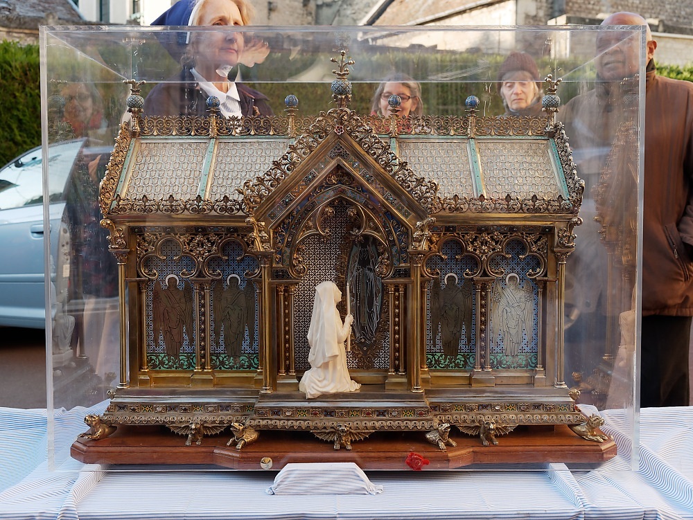 The reliquary of St. Bernadette of Lourdes, depicting Bernadette kneeling at the grotto, outside the Monastery of the Visitation at Caen