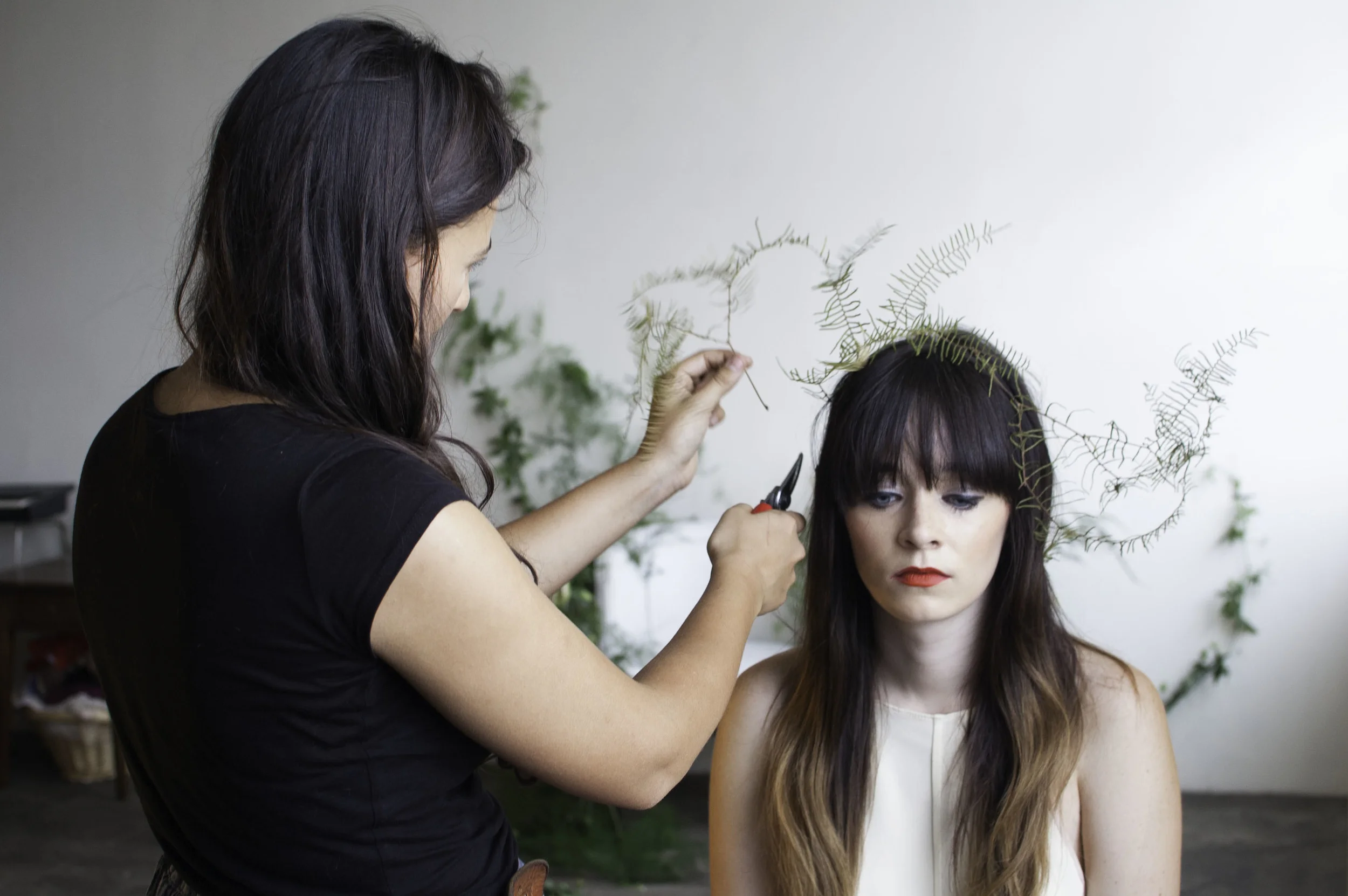 Brittany arranging a flower halo for our model, Rachel Marie 