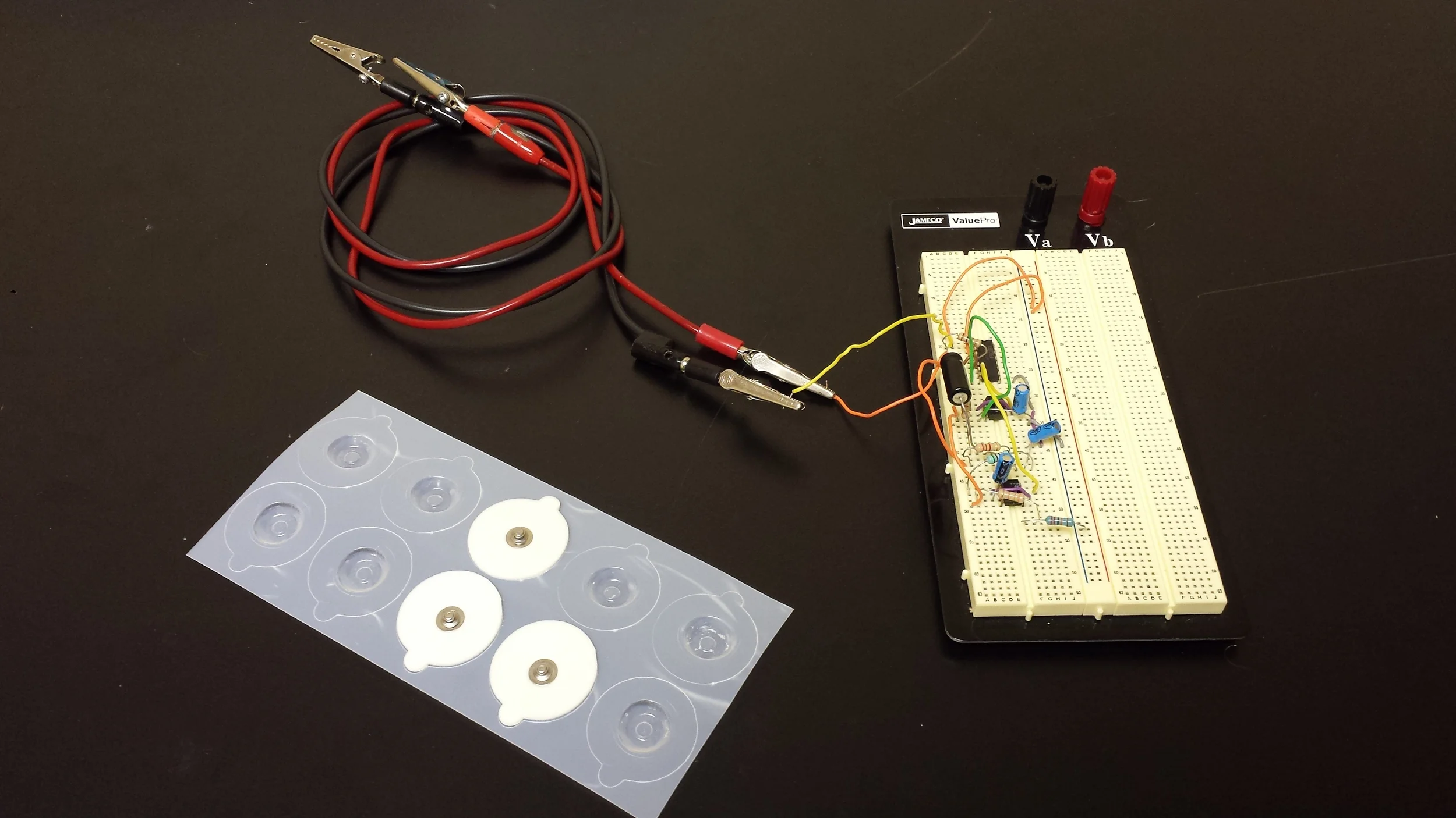 A cascade of analog filters, along with the sticky silver-silver chloride electrodes used for signal acquisition.