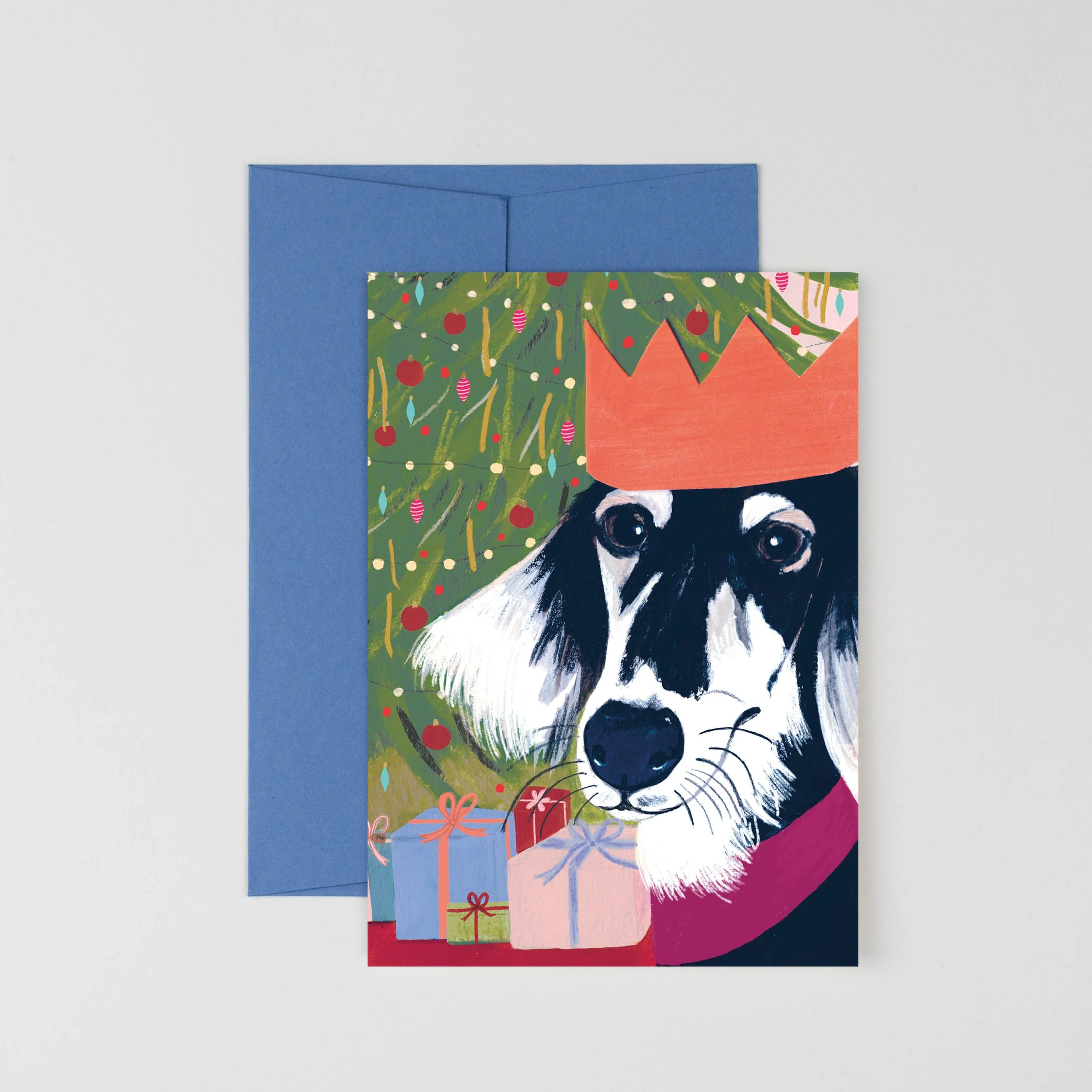 A charming Christmas card featuring a cozy Saluki wearing a paper crown. Illustrated in gouache and printed on eco-friendly card stock.
