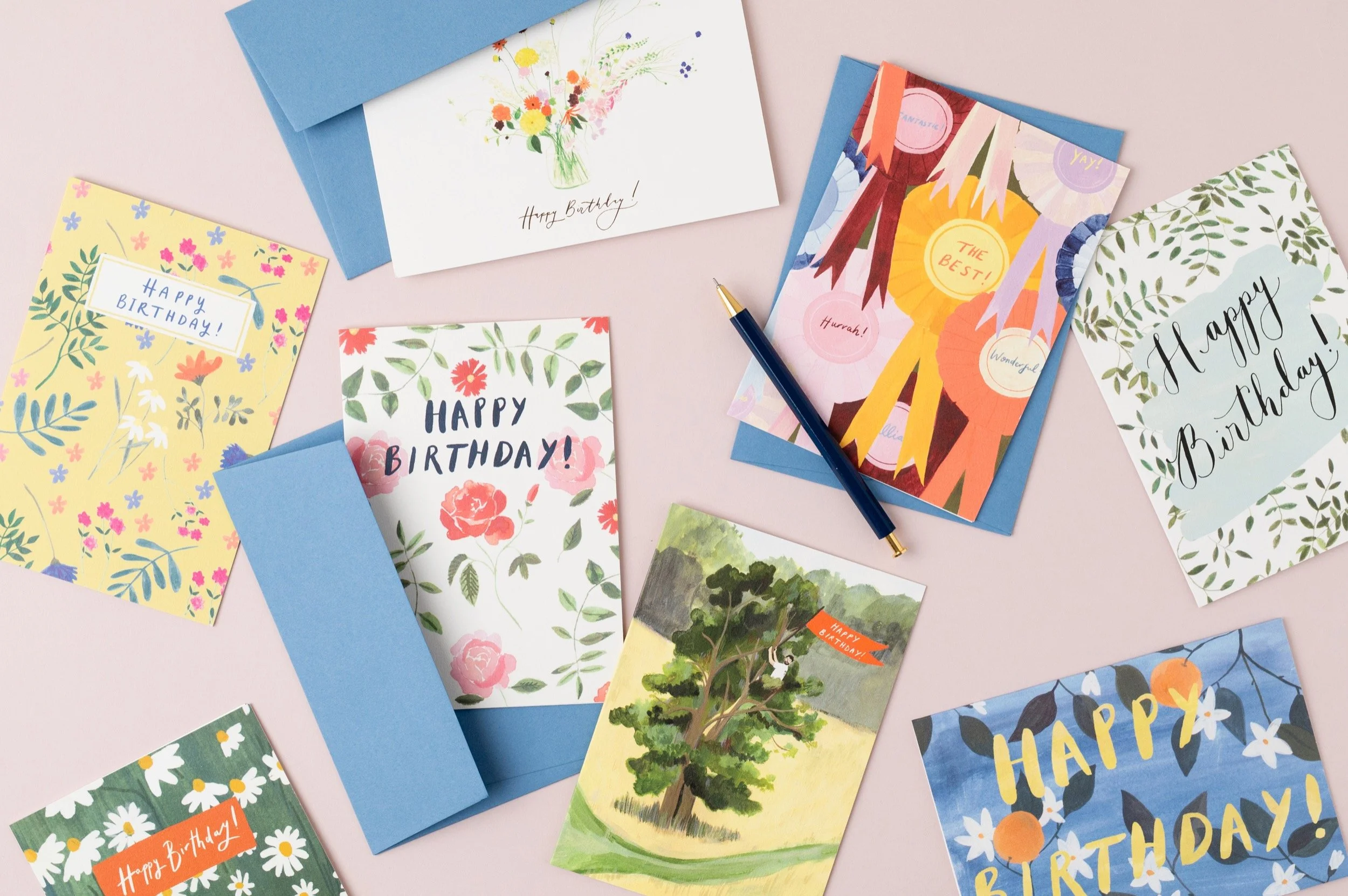 Bundle of hand-painted eco-friendly birthday cards with pale blue envelopes