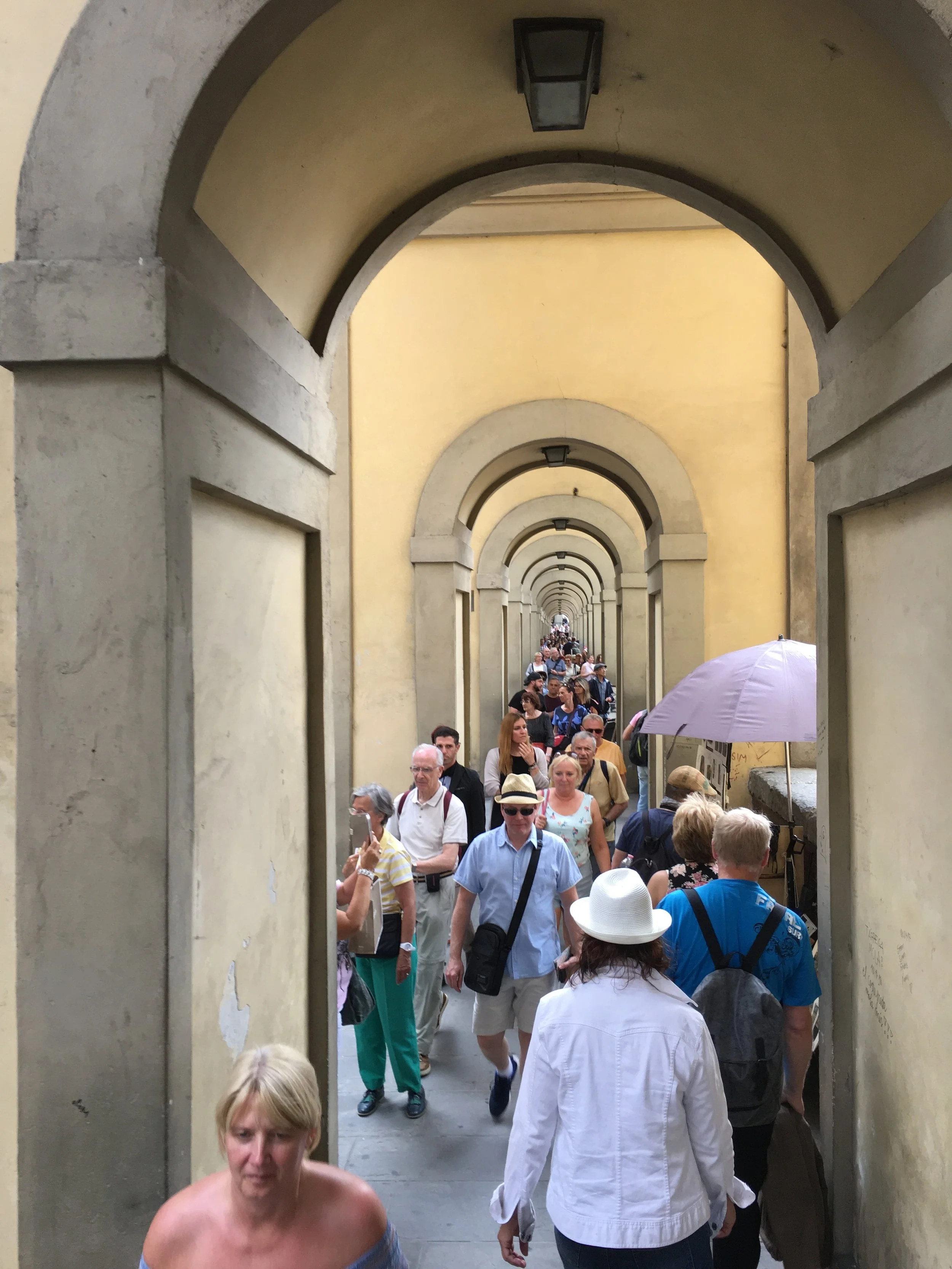 Looking back at the Ponte Vecchio Bridge from the pedestrian walkway.