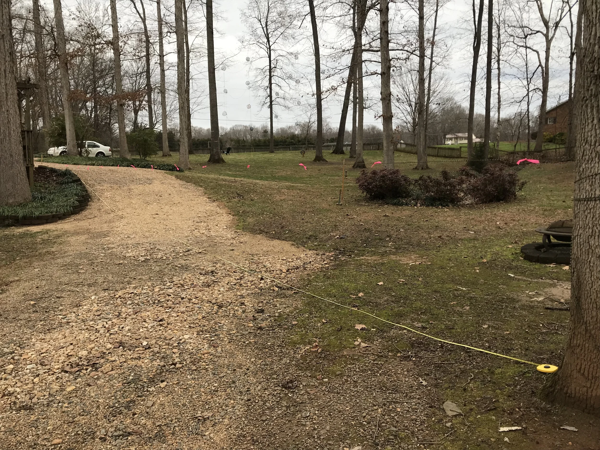 Photo C. This is a view from Lot 47 looking back up at the driveway. Here are some distance measurements for you. They are distance from the stake in the driveway and distances from the string to the ground: 24 feet - 5 inches 30 feet - 11 inches 35 feet - 23 inches 40 feet - 31 inches 45 feet - 41 inches 51 feet - 49 inches 56 feet - 51 inches And from this point to the tree (80 feet), it's about the same distance to the ground as the ground has leveled out.