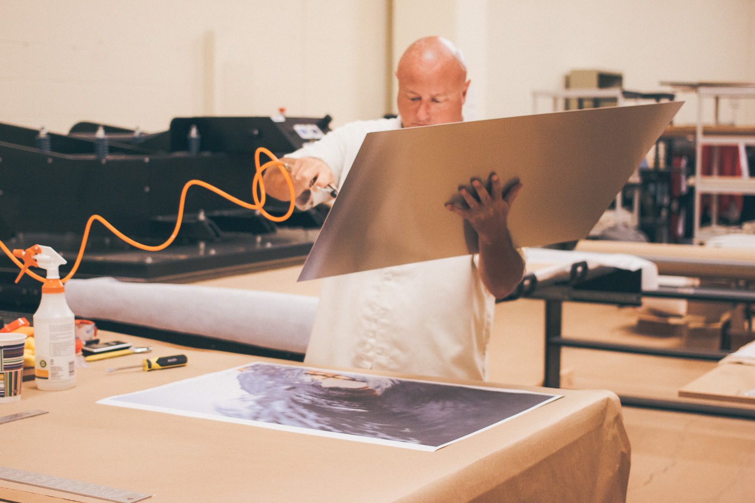 I've worked closely with every printer I have ever used, and Jake is at the top of my list for people I trust to complete a perfect job. He has a real sense of care and dedication when it comes to the final product. Here he is removing dust particles of of the Aluminum reducing the possibilities of spots in your print. 