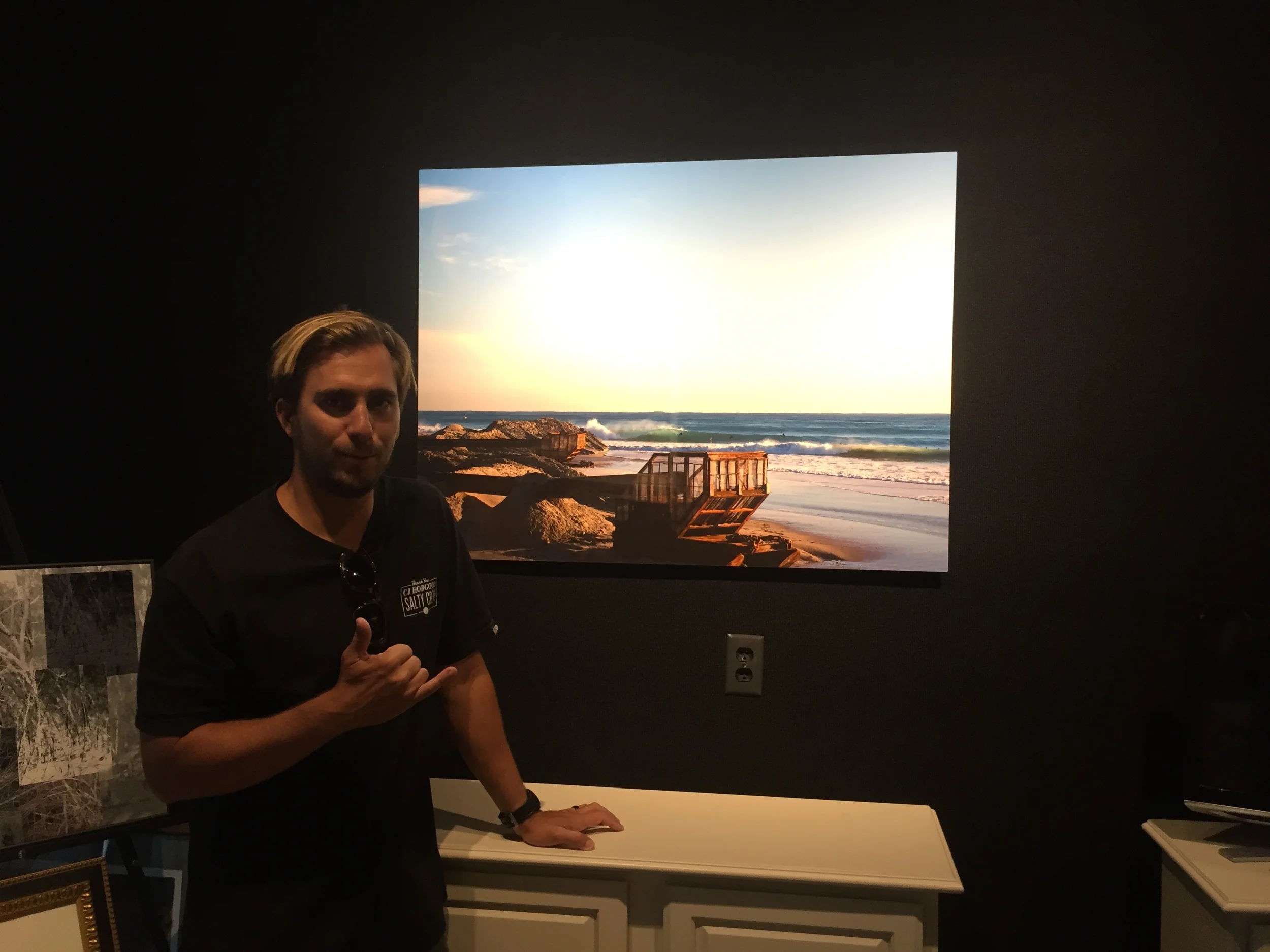 Nathaniel Harrington with "the Dredge", an aluminum print at An Image Evolution in Vero Beach, FL. 