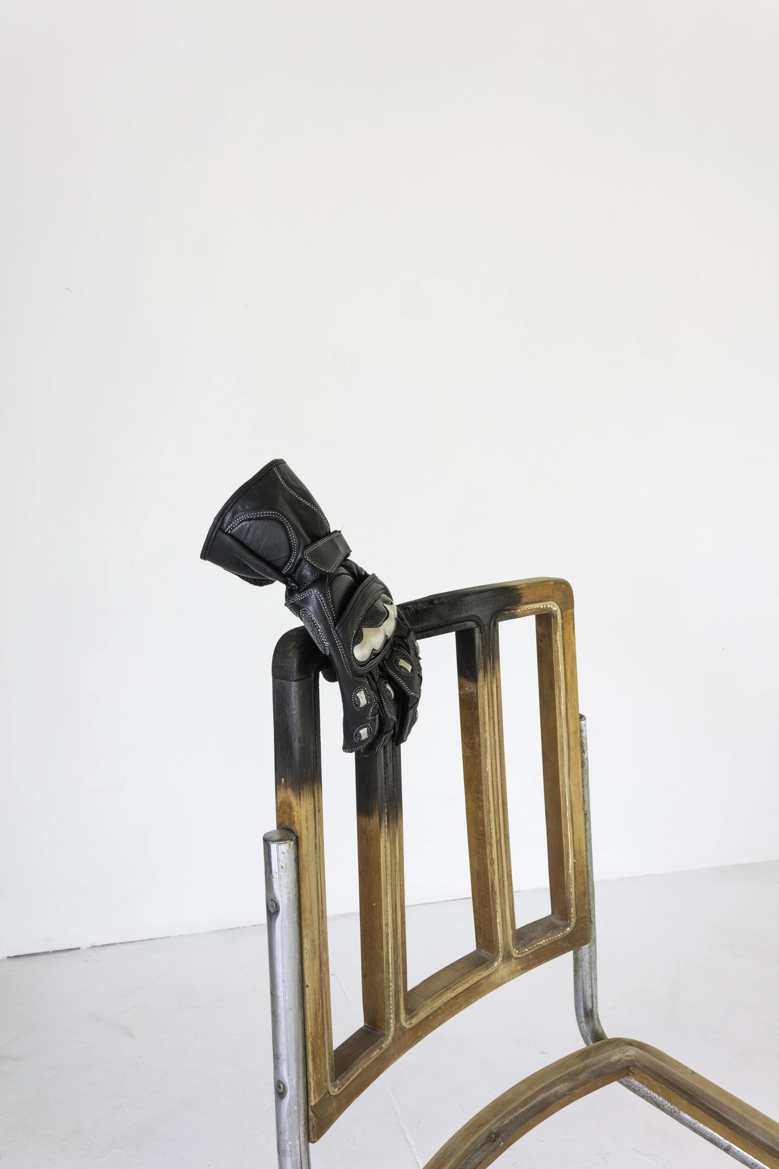 fear of men burned wood and chrome chairs, leather motorcycle gloves
