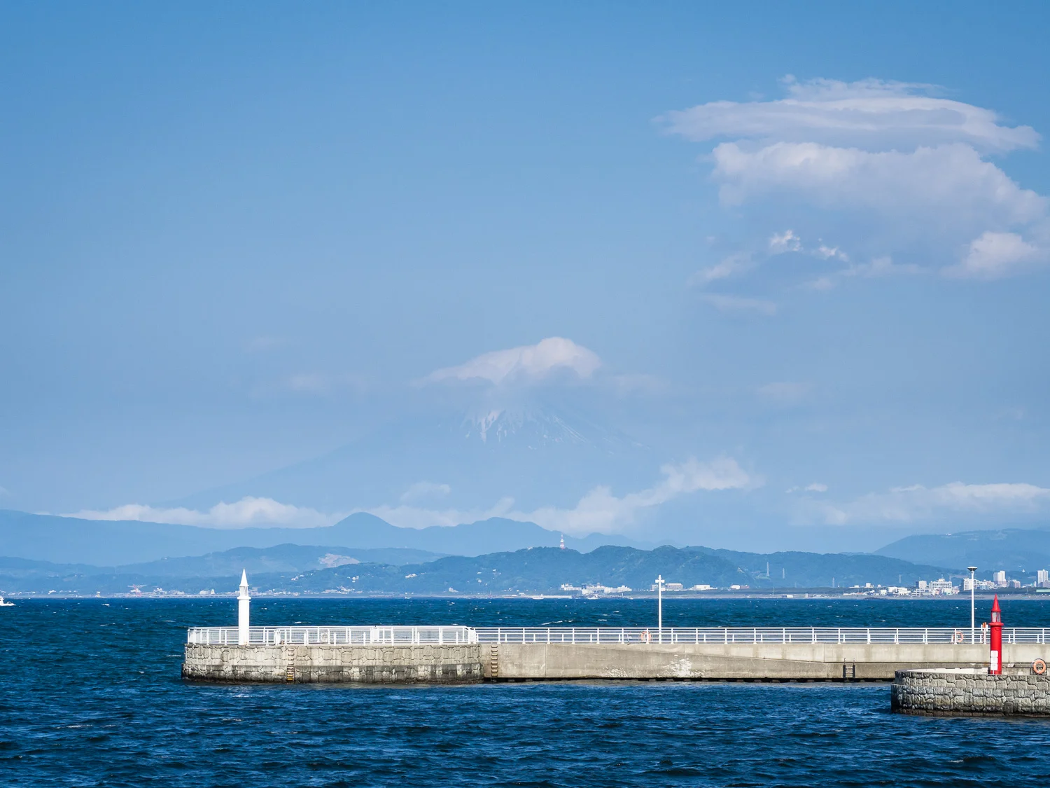 On the bridge to Enoshima looking for Fuji on a warm spring day, the clouds and haze doing their best to obscure the mountain.