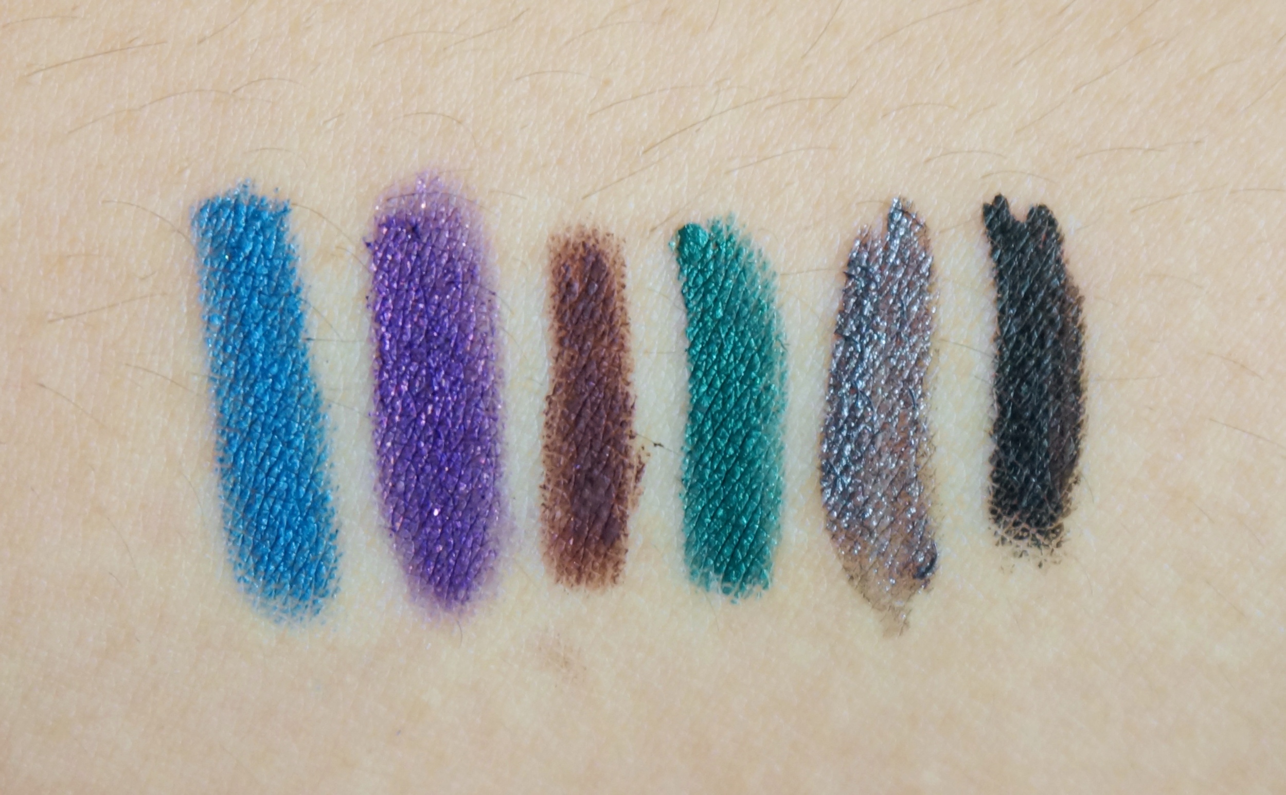Left to right: Essence Long-Lasting Eye Pencil in Cool Down / Eye of Horus Goddess Pencil in Jewel Amethyst / Pixi pencil in Brown / Prestige Total Intensity Eyeliner in Outrageous Emerald / Make Up For Ever Aqua Liner in #17 / K-Palette black eyeliner