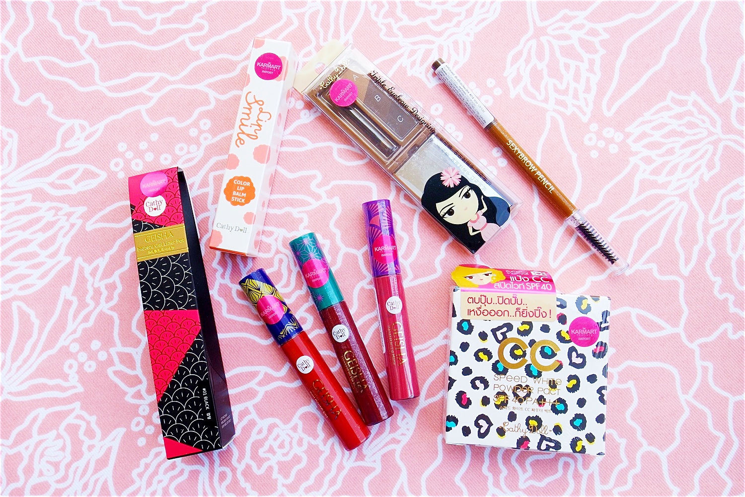 Clockwise from top center: Triple Eyebrow Designing, Sexy Brow Pencil, Speed White CC Powder, Geisha Hanazakari Lip Matte, Geisha Moteru Gel Liner Pot, Lip Smile Color Lip Balm Stick