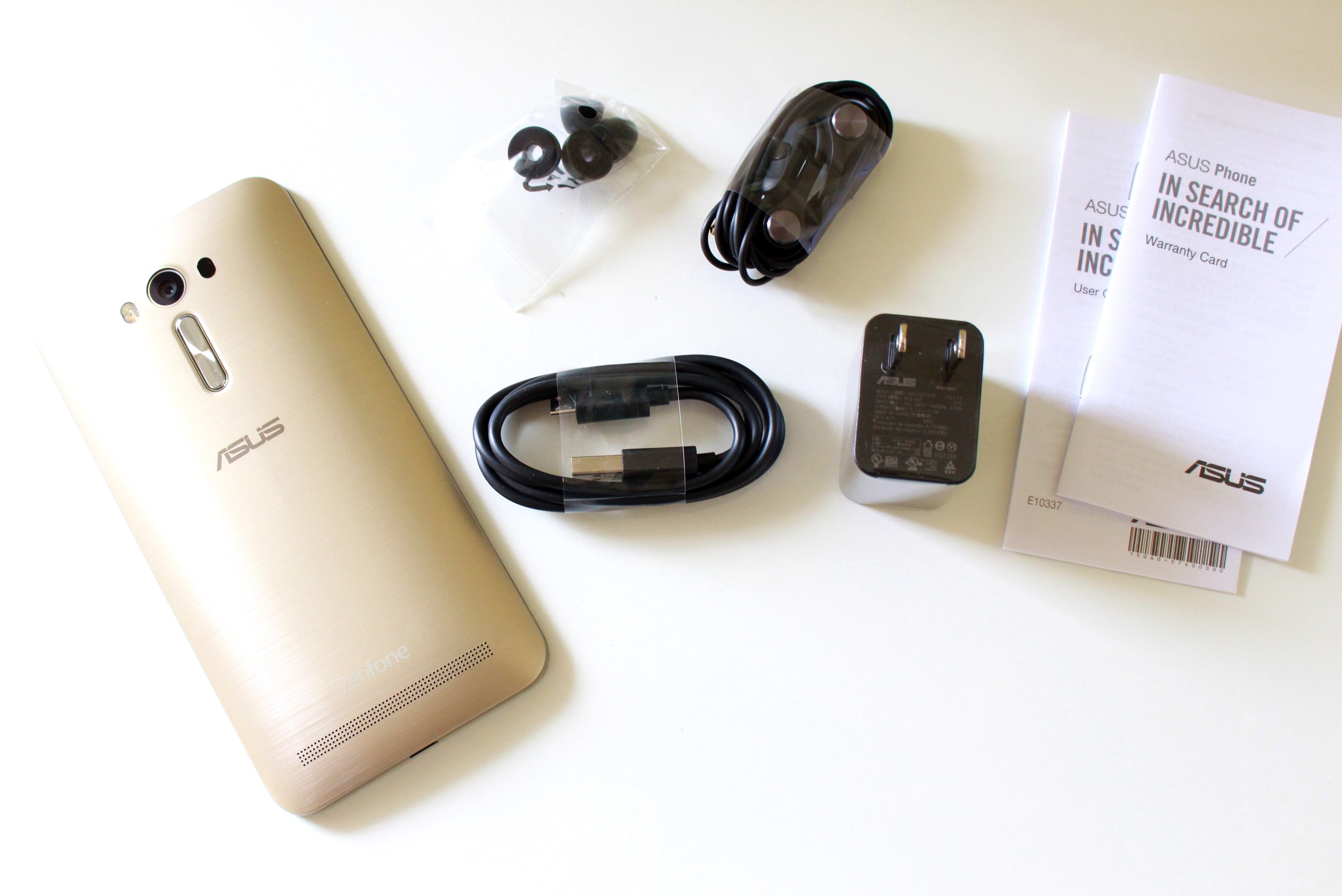 Inside: USB cable, plug, earphones, and rubber covers