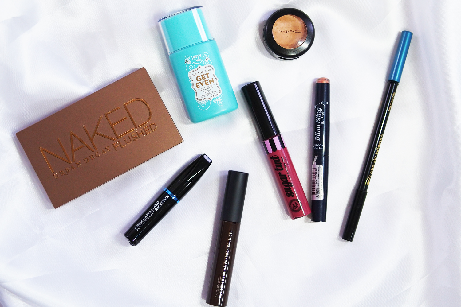 Happy Skin Don’t Get Mad Get Even Hydrating Liquid Foundation, MAC Studio Fix Concealer, Urban Decay Naked Flushed Palette, Etude House Bling Bling Eye Stick in Sunset Star, Pink Sugar SugarTint in Purrfect Pout, Eye of Horus Teal Malachite Goddess Pencil, MAC Pro Longwear Waterproof Brow Set in Brown Ebony, MUFE Aqua Smoky Lash Waterproof Extra Black Mascara