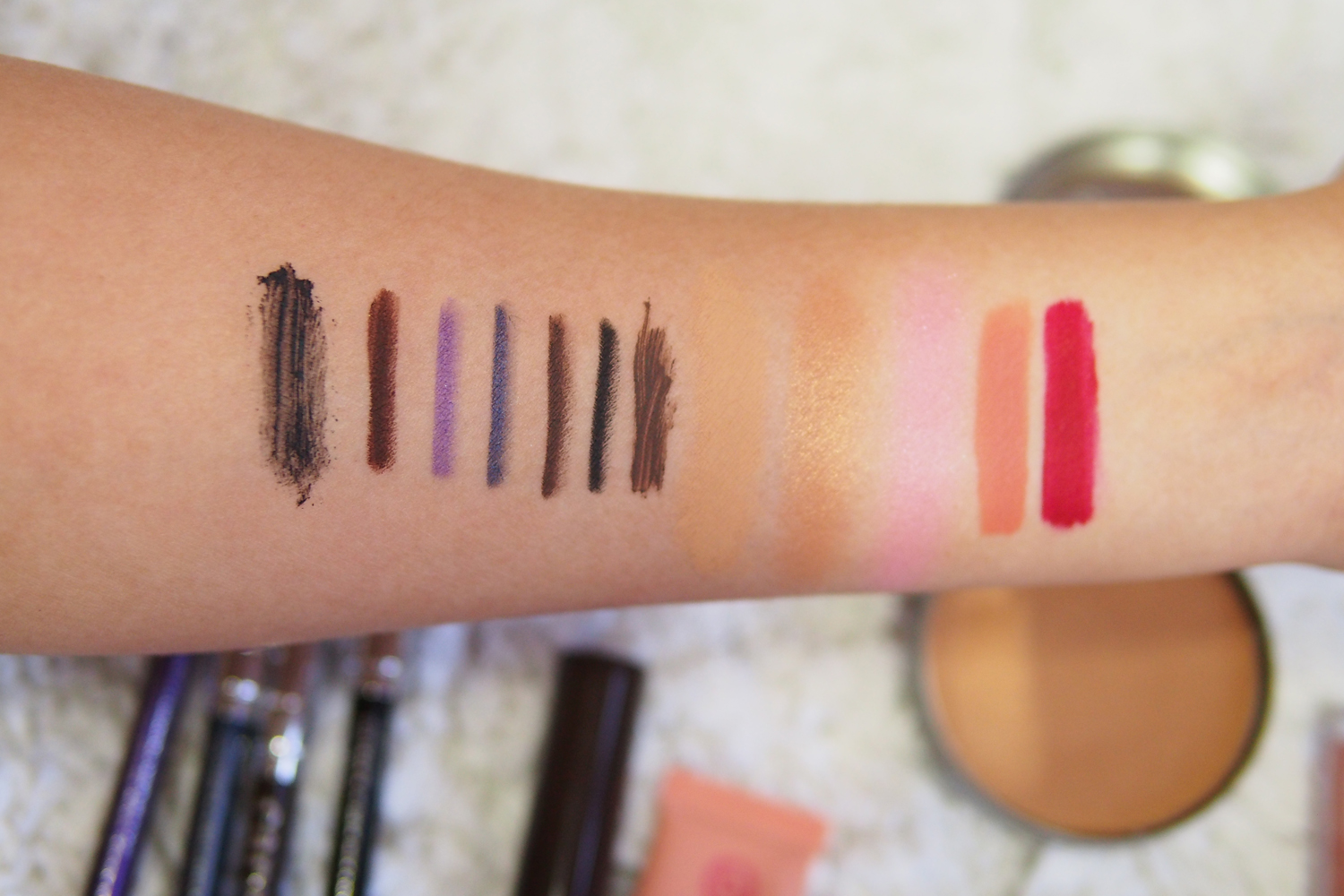 Swatches, from left: MUFE Mascara, MUFE Eye Pencil in M-60, Cargo Eye Pencils in Karon Beach, Loch Ness, Pebble Beach, Black Sea, MAC Brow Set, Pink Sugar Concealer, Cargo Bronzer, Cargo Blush in Ibiza, Ellana Liquid Lipstick in Love is Devotion, Love is True
